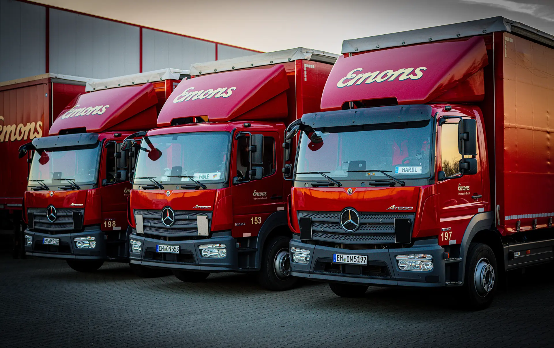Red Emons trucks at the freight forwarding yard — modern vehicle fleet for national and international transport